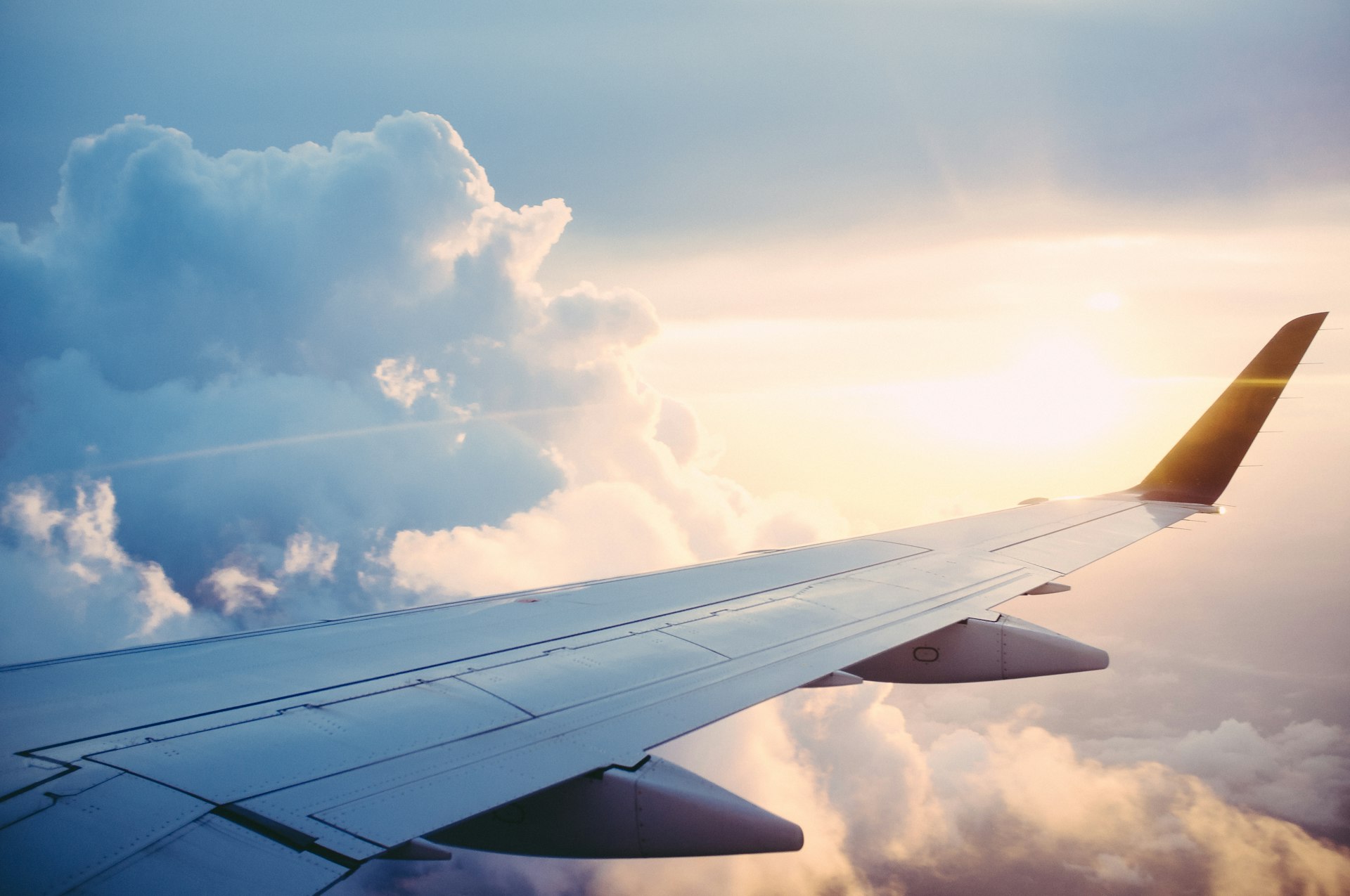 An aircraft wing above the clouds