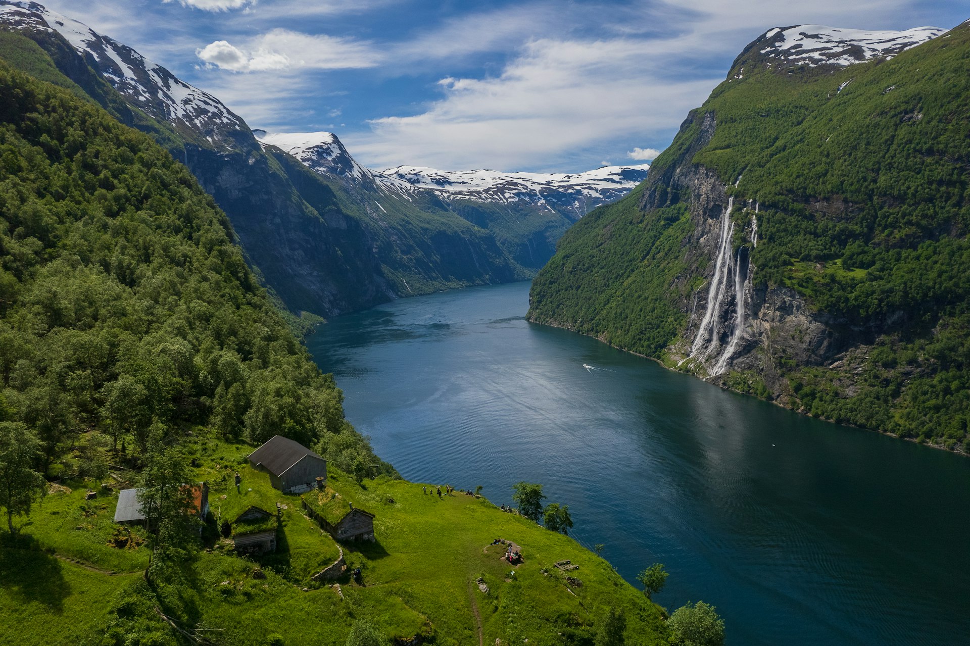 A cruise fjord between steep green cliffs